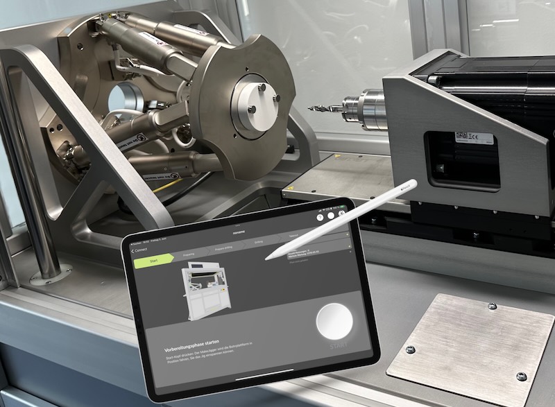 Otomat production machine showing the planning software on an iPad and a hexapod platform for positioning and a drill motor to individualize positioning jigs.